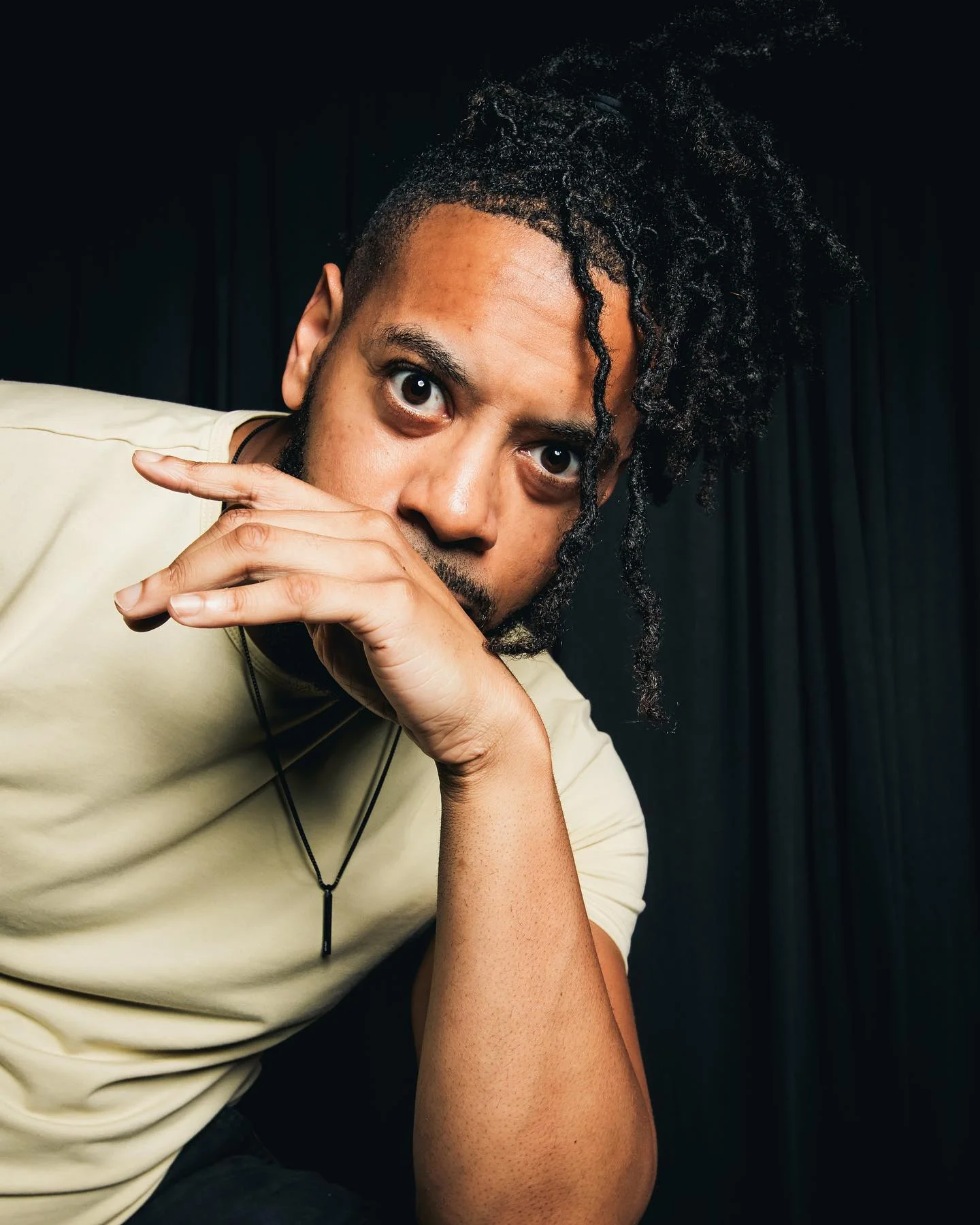 William wearing a cream henley with his current loc hairstyle