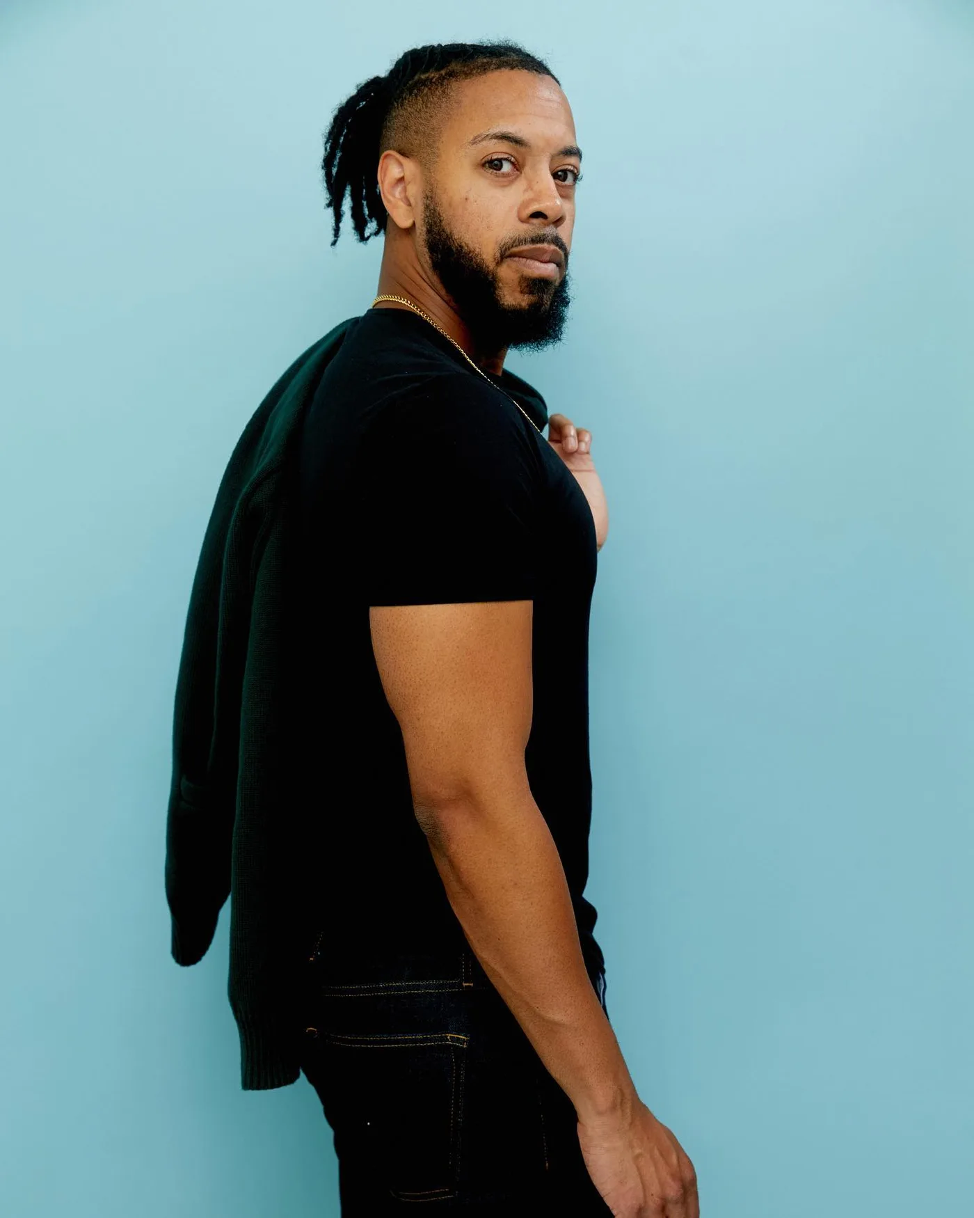 Editorial profile portrait of William against a blue backdrop