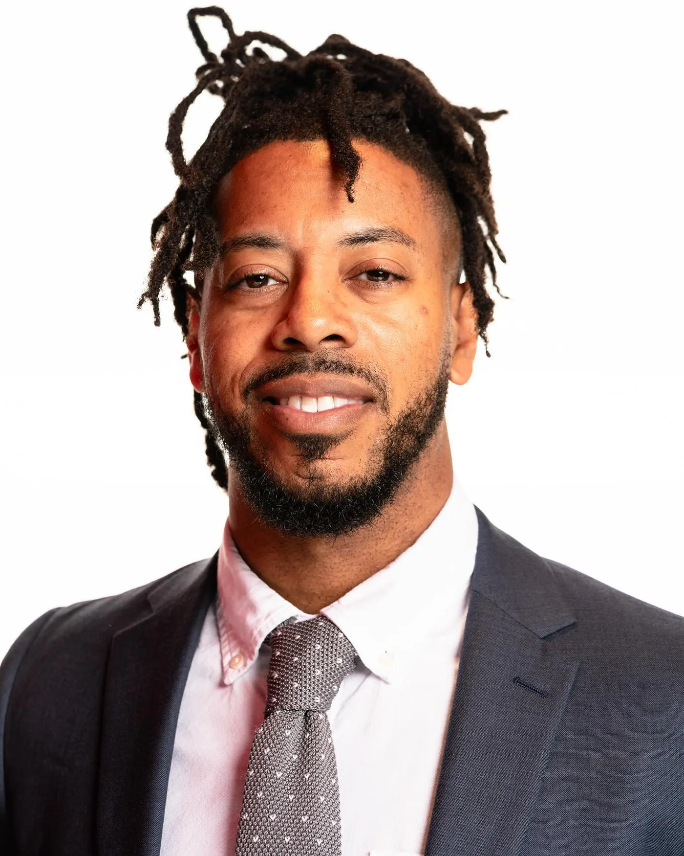 William wearing a navy suit in a commercial headshot