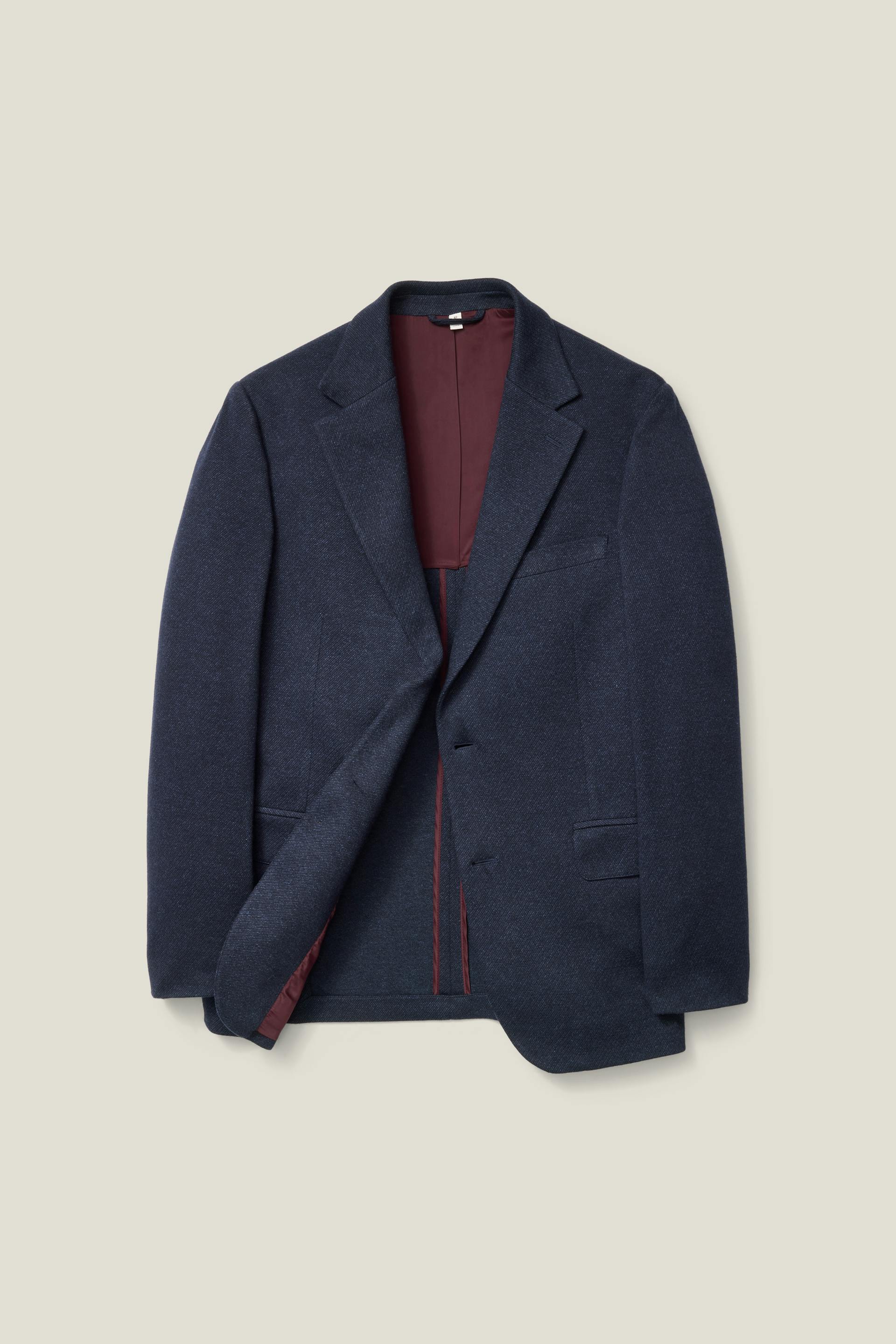 A Bonobos Jetsetter Knit Blazer in Navy Marl Twill on a neutral background.